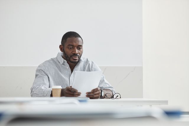 person sitting down and reading a document