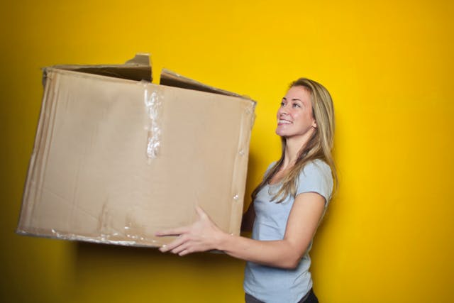 woman holding a moving box