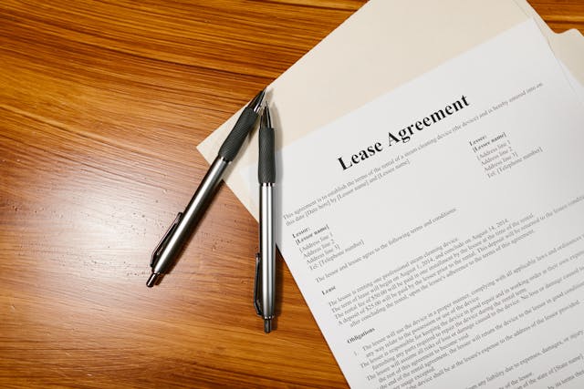 two pens on top of a lease agreement