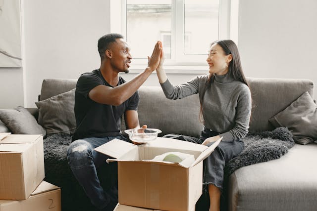 two people celebrating moving into a property