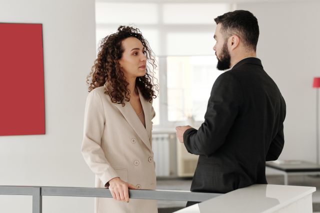 two people having a conversation indoors